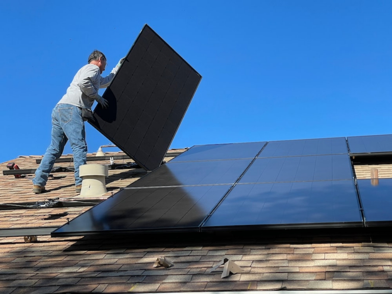 A person installing solar panels.