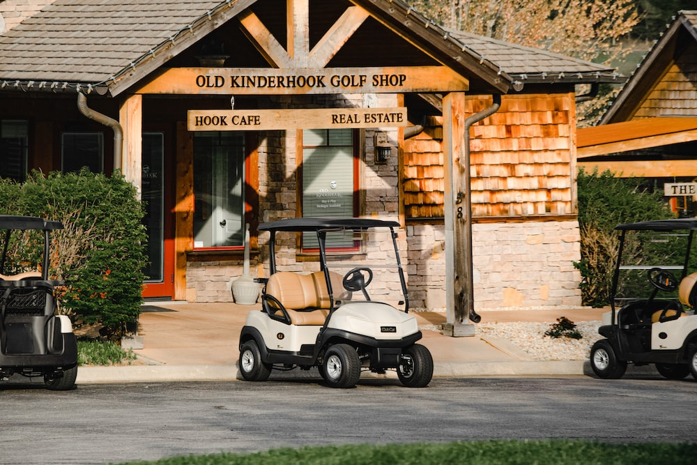 A golf cart parked outside a golf shop